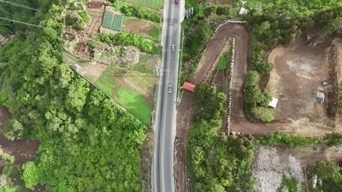 Top Down Aerial View of Mountain Road and Vegetable Farms Stock Footage 343580477