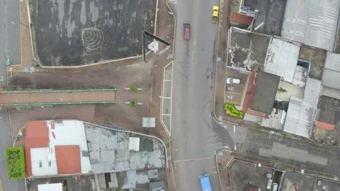 Top down aerial view moving along a road with cars waiting for a red light Stock Footage 146351557