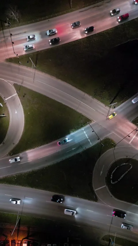 Top down aerial view of a night intersection with a moving traffic. Vehicles Stock Footage 300486046
