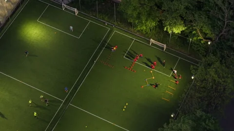 Top-Down Aerial View of Night Soccer Game in Sofia Park Lit by Stadium Lights Video stock 309164664