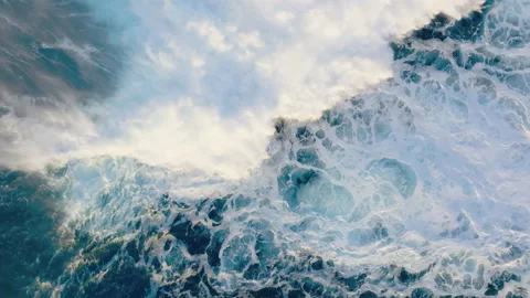 Top down aerial view of ocean wave textures crashing on sunny day Stock-Footage 227418575
