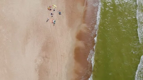 Top Down Aerial View of Ocean Waves Rolling onto a Sandy Seashore Stock Footage 321752846