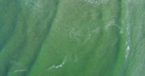 Top Down Aerial View of Ocean Waves on a Sandy Beach Stock Footage 324750790