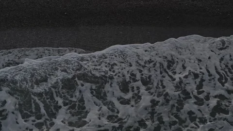 Top Down Aerial View of Ocean Waves Breaking on Dark Sand Beach Stock Footage 342470597