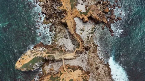 Top-Down Aerial View of Orange Sandstone Rock Formations by the Sea Stock-Footage 345841897