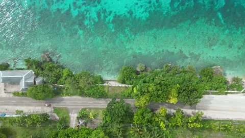 Top down aerial view over a scenic coastal road with a traveling car. Stock Footage 204918267
