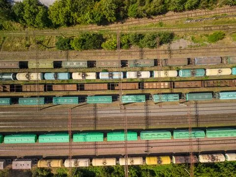Top down aerial view of parallel railway tracks with multiple cargo trains .. Fotos Stock