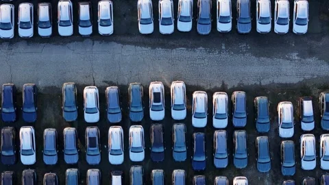Top down aerial view of parked cars arranged in parallel rows forming a Stock Footage 327467777