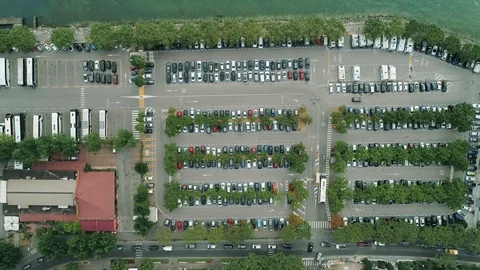 Top down aerial view of a parking square with lots for every type of vehicle Stock Footage 119358507