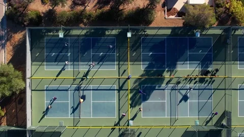 Top down aerial view people playing pickleball on outdoor sport courts Video stock 221295130
