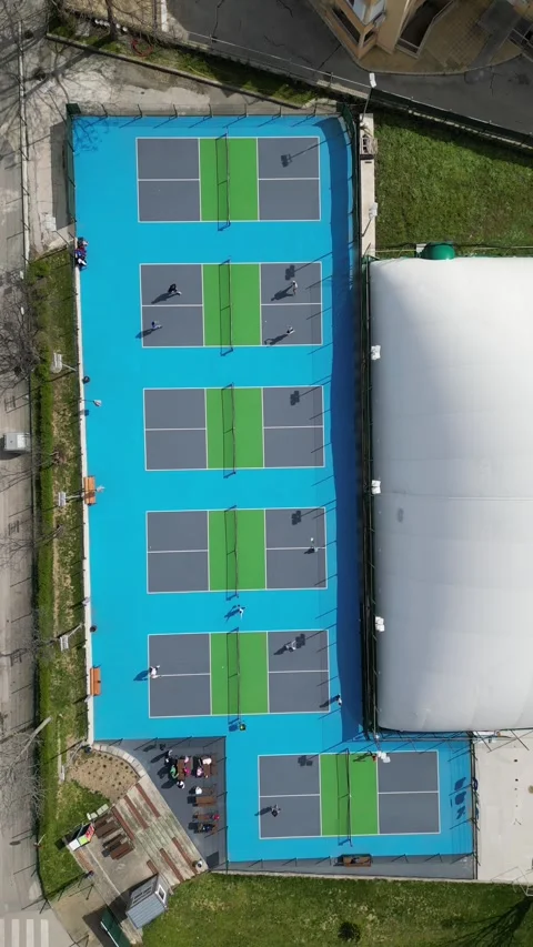 Top Down Aerial View of People Playing Pickleball on Blue Courts Video stock 332712659