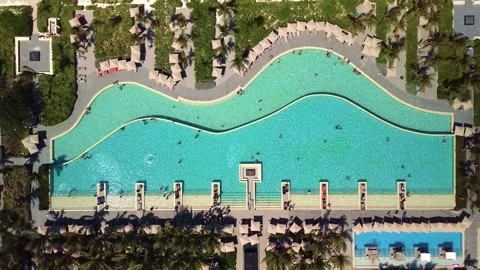 Top down aerial view of pool on grounds of a luxury hotel in tropics. Palm trees Видео 274372163