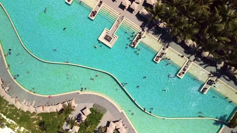 Top down aerial view of pool on grounds of a luxury hotel in tropics. Palm trees Vídeos de archivo 274372413