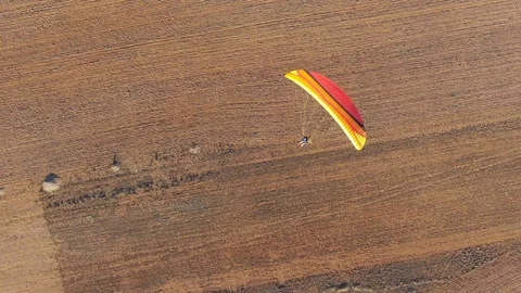 Top down aerial view of powered paragliding enjoying gliding in the air Stock Footage 117697902