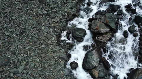 Top down aerial view of powerful mountain river rapids and wet boulders Stock Footage 334625218