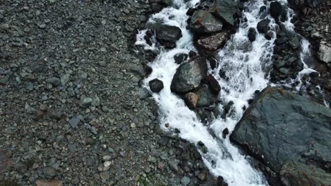 Top down aerial view of powerful mountain river rapids and wet boulders Stock Footage 335077033