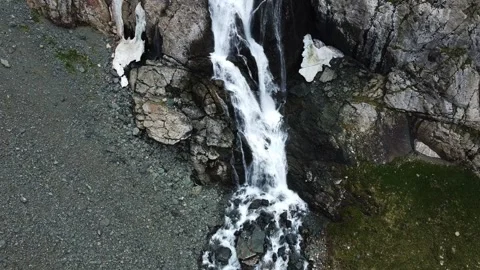 Top down aerial view of powerful waterfall cascading down rocky cliffs Stock Footage 335093790
