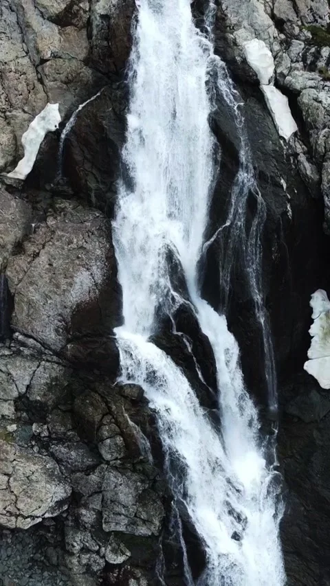 Top down aerial view of powerful waterfall cascading down rocky cliffs Stock Footage 336685632