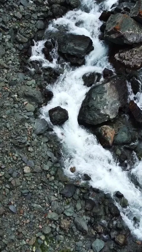Top down aerial view of powerful mountain river rapids and wet boulders Stock Footage 336685879