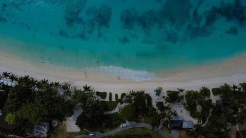 Top-Down Aerial View of Pristine White Sand Beach and Crystal Clear Ocean Water Stock Photos