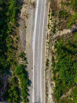 Top-down aerial view of a quiet forest road corridor Stock Photos