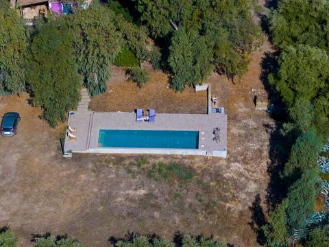 Top down aerial view of a rectangular private swimming pool surrounded by t.. Foto stock