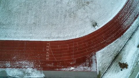Top Down Aerial View of Red Running Track Starting Line and Lane Numbers Stock Photos