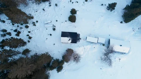 Top down aerial view of remote snow covered cabin in norwegian woods in Stock Footage