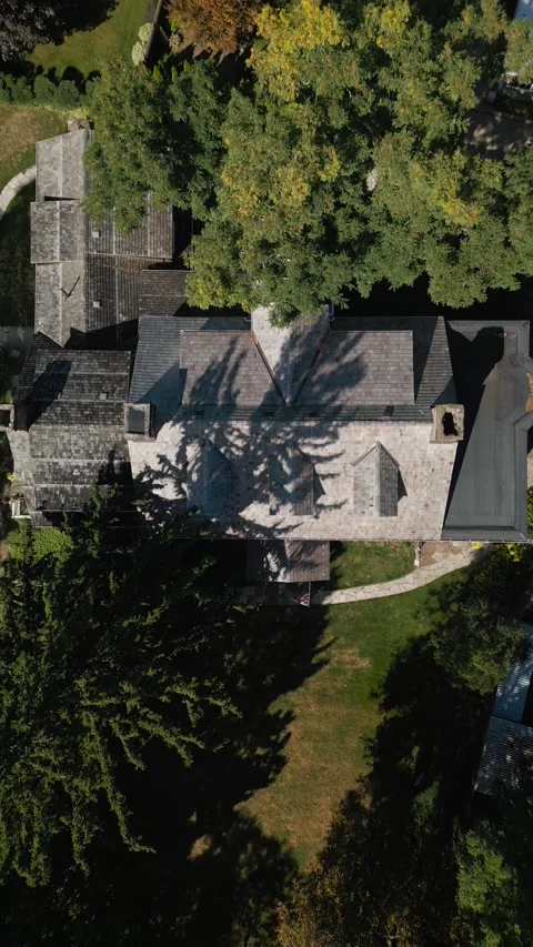 Top-down aerial view of residential home with trees and shadows Video stock 317358599