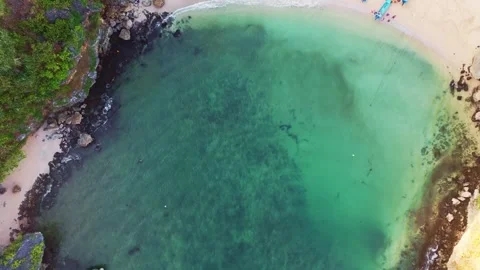 Top-down aerial view reveals clear turquoise water, sandy beach, and fishin.. Stock Footage 341545465