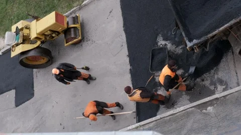Top down aerial view of road construction workers and roller repairing stre.. Stock Footage 339802132