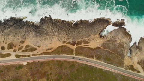 Top down aerial view rocky ocean shore with scenic coastal road Video stock 107962425