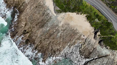 Top-down aerial view of rocky coastline and waves along the Great Ocean Road Video stock 325539294