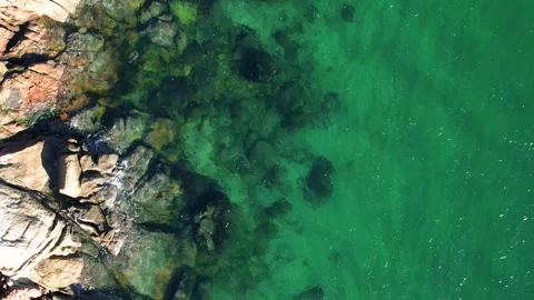 Top Down Aerial View of a Rocky Coast with Clear Water The Concept of Purity Stock Footage 327814564