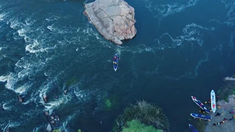 A top-down aerial view of rowers on kayak docking to the shore. Stock Footage 166338239