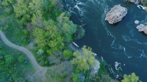 A top-down aerial view of the rowers disembarking from boat races on the river. Stock Footage 166916096