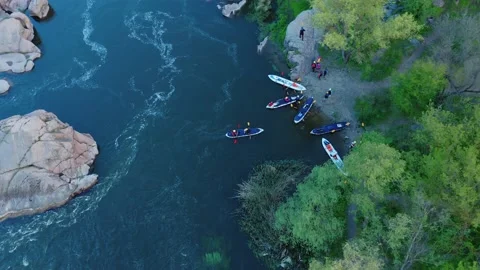A top-down aerial view of rowers on kayak docking to the coast. Stock Footage 167129896
