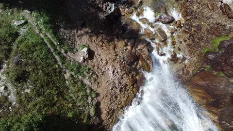 Top down aerial view of rushing white water river and giant wet boulders Stock Footage 335093554