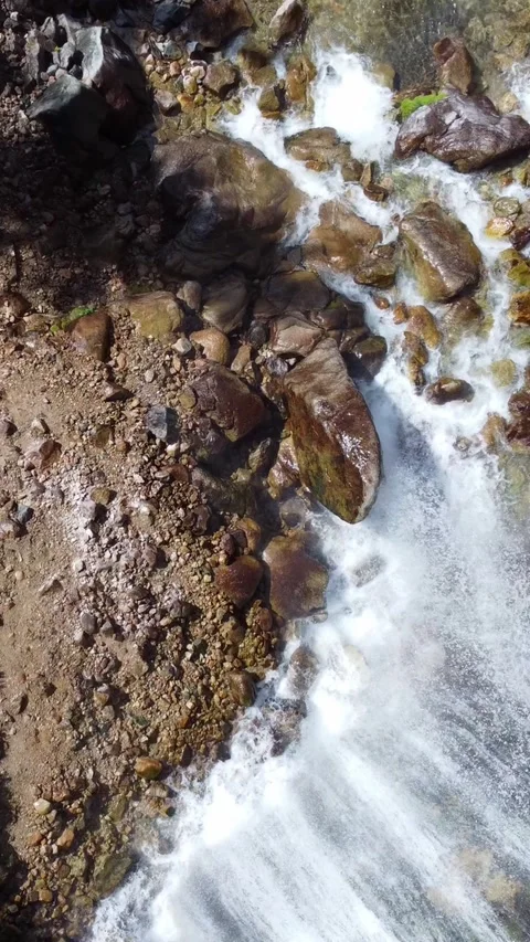 Top down aerial view of rushing white water river and giant wet boulders Stock Footage 336691645