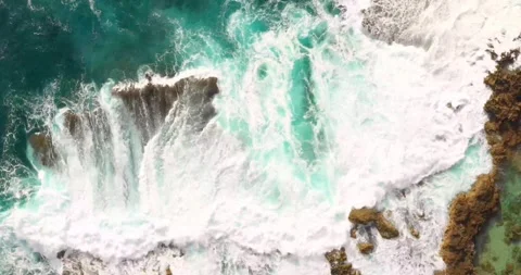 Top-Down Aerial View of Sea Waves Crashing onto a Sandy Beach Shore Stock Footage 340554952
