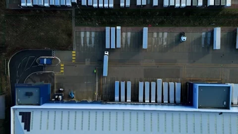 Top down aerial view of a semi-truck HGV reversing into a warehouse loading bay. Stock Footage 335975535