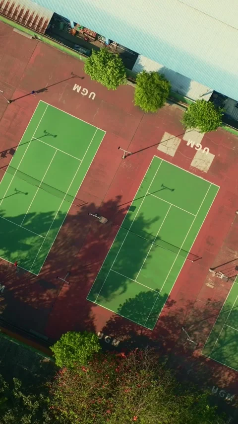 Top down aerial view of several green tennis courts in Yogyakarta 動画素材 342589672