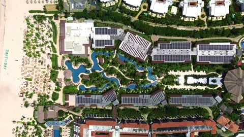 Top down aerial view of showcasing tropical resort lively swimming pool, family Stock Footage 273870644