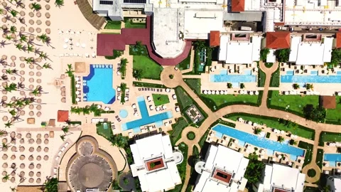 Top down aerial view of showcasing tropical resort lively swimming pool, family Stock Footage 273871081