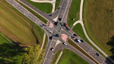 Top-down aerial view showing traffic at a road intersection with bike lanes Video stock 320813178