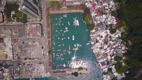 Top-down aerial view on small artificial bay beside slum and urban area Stock Footage 76797641