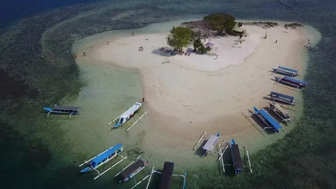 Top down aerial view on small island with tourist boats docking Stock Footage 129057647