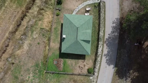 Top-Down Aerial View of a Small Rural House with a Green Roof Stock Footage 289222617
