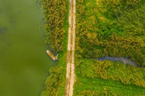 Top down aerial view of small rowing boat near coast of lake 写真素材