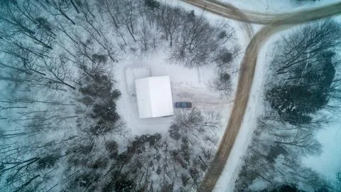 Top Down Aerial View of Snow Covered House and Winter Dirt Road 스톡 사진